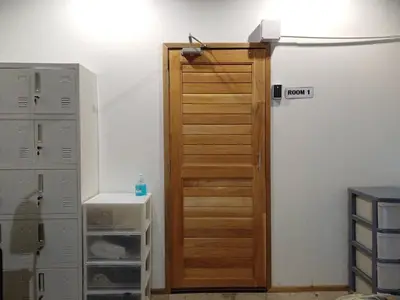 a wooden door in a room with some boxes at Amsterdamned (อัมสเตอร์ดัมด์) in Bangkok