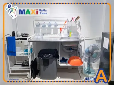 a toy kitchen with a sink and a fan at MAXi MaMa House in Bangkok