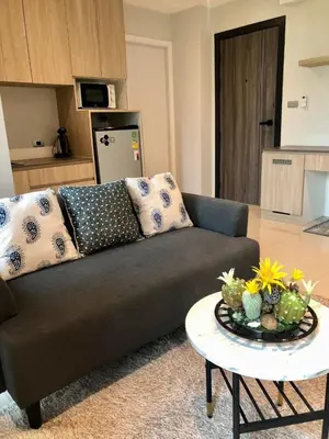 a living room with a couch and a table at BaanTip​ HomStay in Bangkok