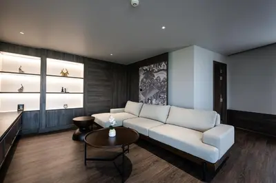a living room with a white couch and a table at WE HOTEL RIVERFRONT in Bang Su