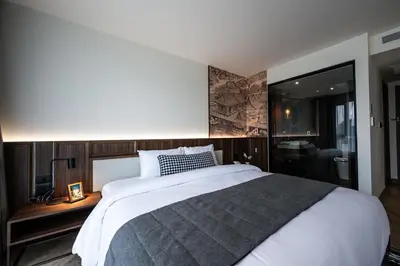 a bedroom with a large white bed and a window at WE HOTEL RIVERFRONT in Bang Su