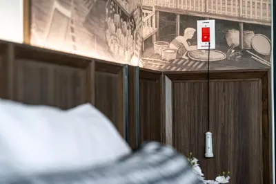 a room with a counter with a picture of a kitchen at WE HOTEL RIVERFRONT in Bang Su