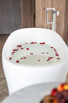 a white toilet with confederateacistacistacistacist at WE HOTEL RIVERFRONT in Bang Su
