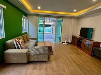 a living room with a couch and a flat screen tv at Stay Tender in Bang Su
