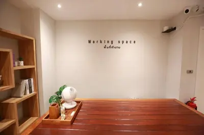 a room with a white wall with a sign on it at BaanTip​ HomeStay in Amphoe Phra Khanong