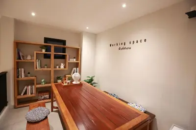 a room with a wooden bench and a book shelf at BaanTip​ HomeStay in Amphoe Phra Khanong