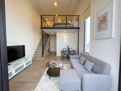 a living room with a couch and a tv at Siamese 87 2BR \u7d20\u5764\u9038 BTS On Nut LOFT \u4e24\u623f 25 in Bangkok
