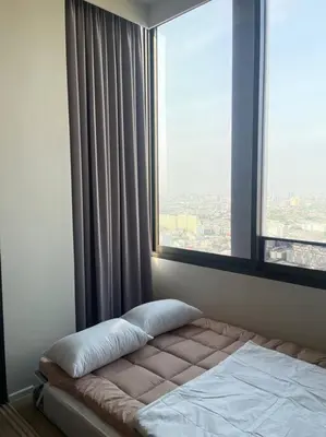 a bed in a room with a large window at Siamese 87 2BR \u7d20\u5764\u9038 BTS On Nut LOFT \u4e24\u623f 25 in Bangkok