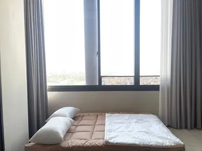 a bed in a room with a large window at Siamese 87 2BR \u7d20\u5764\u9038 BTS On Nut LOFT \u4e24\u623f 25 in Bangkok
