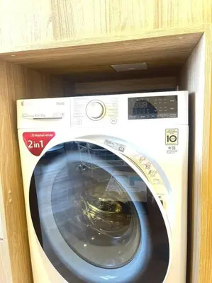 a washing machine is in a wooden shelf at Siamese 87 2BR \u7d20\u5764\u9038 BTS On Nut LOFT \u4e24\u623f 25 in Bangkok