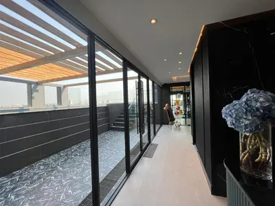 a hallway of a building with glass windows at ARNI Skye Hotel in Bangkok