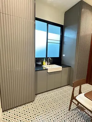 a bathroom with a sink and a window at House40 MRT Ratchadaphisek in Bangkok