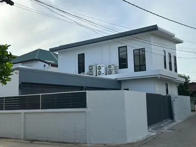 a white house with a fence in front of it at House40 MRT Ratchadaphisek in Bangkok