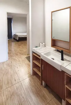 a bathroom with a sink and a mirror and a bed at Chubby 9 Standard room in Ban Bang Phlat