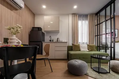 a kitchen and a living room with a couch and a table at 3 Bed 3 Bath / Luxury / 1 min walk to BTS Asok in Bangkok