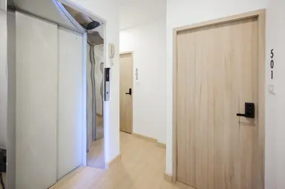a sliding door in a room with a hallway at 3 Bed 3 Bath / Luxury / 1 min walk to BTS Asok in Bangkok
