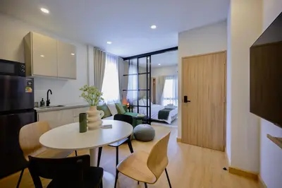 a kitchen and living room with a table and chairs at 3 Bed 3 Bath / Luxury / 1 min walk to BTS Asok in Bangkok