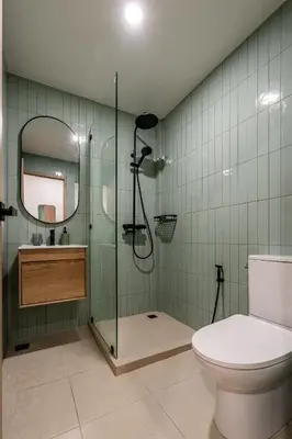 a bathroom with a shower and a toilet and a mirror at 2 Bed 2 Bath / Luxury / 1 min walk to BTS Asok in Bangkok