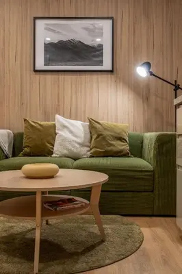 a living room with a green couch and a coffee table at 2 Bed 2 Bath / Luxury / 1 min walk to BTS Asok in Bangkok