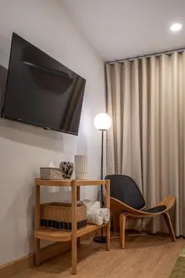 a living room with a tv and a chair at 2 Bed 2 Bath / Luxury / 1 min walk to BTS Asok in Bangkok