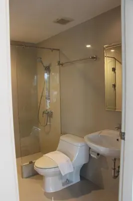a bathroom with a toilet and a shower and a sink at Entire 3BR Townhome, Pool, Sukhumvit, BTS&MRT Asok in Bangkok
