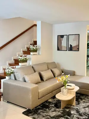 a living room with a couch and a staircase at Entire 3BR Townhome, Pool, Sukhumvit, BTS&MRT Asok in Bangkok