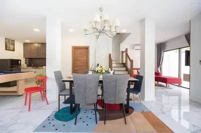 a dining room and kitchen with a table and chairs at MIQ Ekkamai3_Pool Villa_3BR house in Bangkok