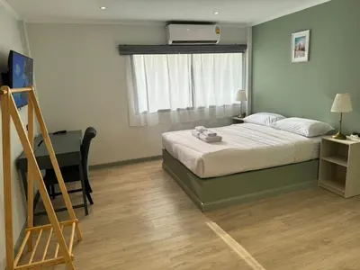 a small bedroom with a bed and a window at O'Shea's Sukhumvit Bangkok in Khlong Toei
