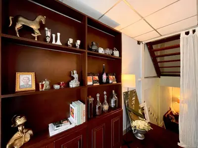 a book shelf filled with lots of vases at MIDNIGHT CREPES Homecafe/Lifestyle Studio in Ban Bang Toei (1)