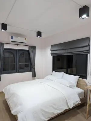a white bed in a room with two windows at Cloud9 Hometel - Entire House 3BR 170m to BTS Private Quiet & Comfy in Bangkok