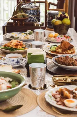 a table full of plates of food on a table at Wallaya Heritage Stay in Bangkok