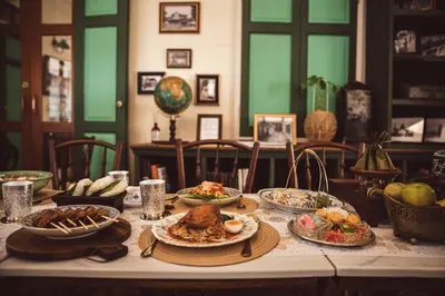 a table with plates of food on top of it at Wallaya Heritage Stay in Bangkok