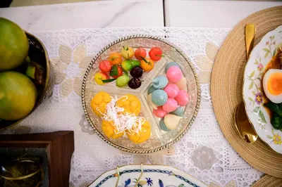 a table with a plate of food on a table at Wallaya Heritage Stay in Bangkok