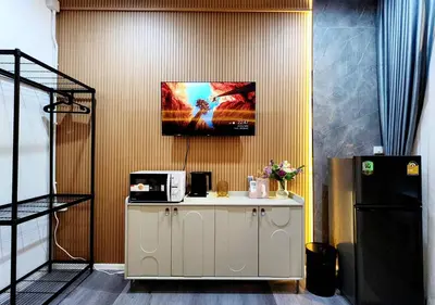 a room with a counter with a tv on the wall at Lasalle House - 4- storey entire house with rooftop 200 sqm Suvarnabhumi airport ,BTS in Bangkok