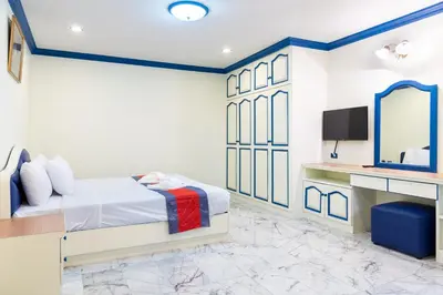 a hotel room with a bed and a tv at 75 Paradise Lane Managed by Loft Group in Bangkok