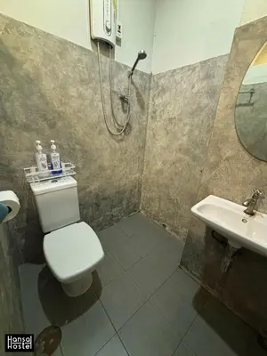 a bathroom with a toilet and a sink at Hansa Hostel Bangkok Khaosan in Bangkok