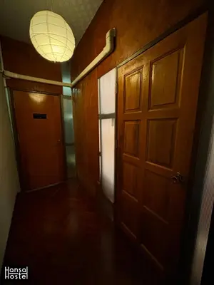 an empty hallway with a door and a light at Hansa Hostel Bangkok Khaosan in Bangkok