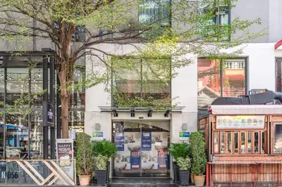 a building with a store on the street at Holiday Inn Express Bangkok Sukhumvit 11 by IHG in Bangkok