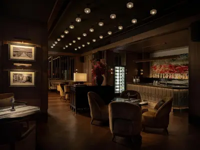 a restaurant with tables and chairs and a bar at Dusit Thani Bangkok in Bangkok