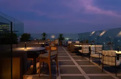 a restaurant with tables and chairs on a roof at Dusit Thani Bangkok in Bangkok