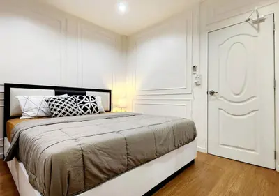 a white bedroom with a bed and a white door at Cozy House,4 rooms, bts ,Mega Bangna,Suvarnabhumi in Bangkok