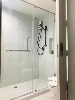 a shower with a glass door in a bathroom at Urban house in Bangkok
