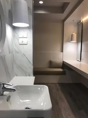 a bathroom with a white sink and a mirror at Urban house in Bangkok