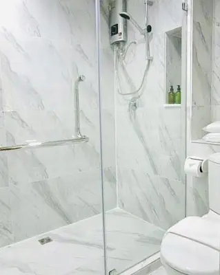 a shower with a glass door in a bathroom at Urban house in Bangkok
