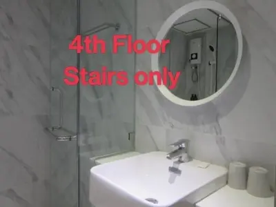 a bathroom with a white sink and a mirror at Urban house in Bangkok