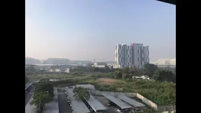 a view of a parking lot with a tall building at OP Open View เมืองทอง T12 impact muang thong thani in Ban Bang Phang