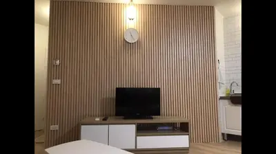 a room with a television and a clock on a wall at OP Open View เมืองทอง T12 impact muang thong thani in Ban Bang Phang