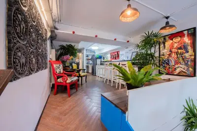 a lobby of a restaurant with tables and chairs at Mascotte Hostel Silom in Bangkok