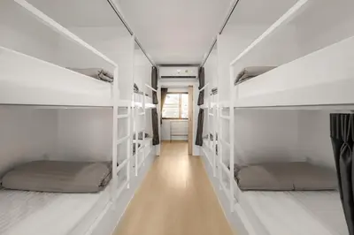 a hallway with four bunk beds in a room at The 63rd Hostel in Bangkok