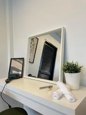 a mirror sitting on top of a white desk at Spacious Design Loft with Rooftop in Bangkok